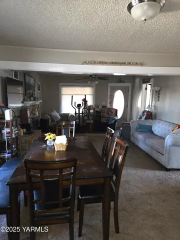 a dining room with furniture and wooden floor