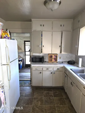 a kitchen with a sink and cabinets