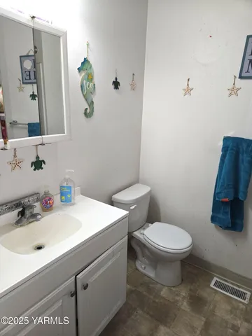 a bathroom with a sink a toilet and mirror