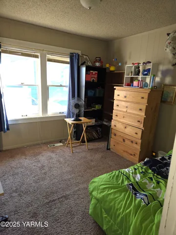 walk in closet with clothes and shoes