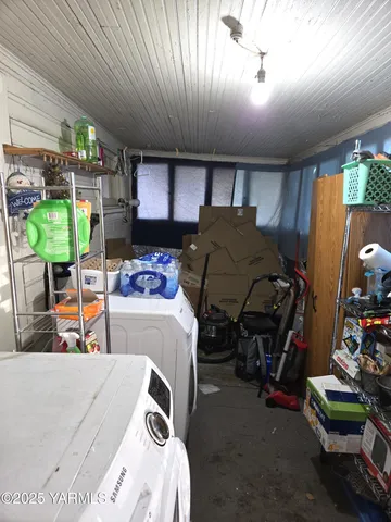 a bedroom with furniture and a large window