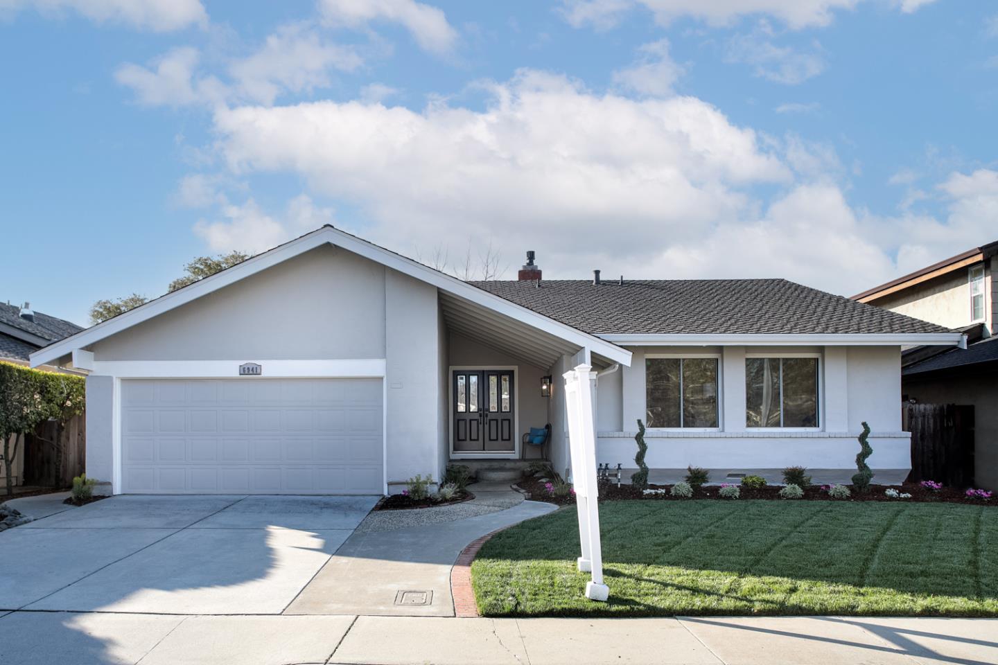 a front view of a house with garden