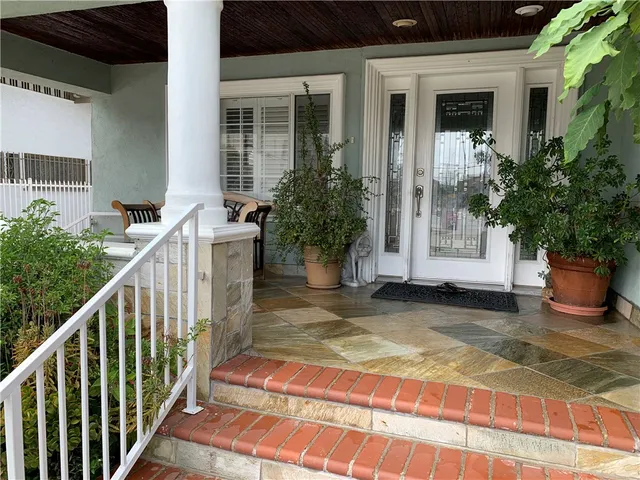 a view of a house with potted plants