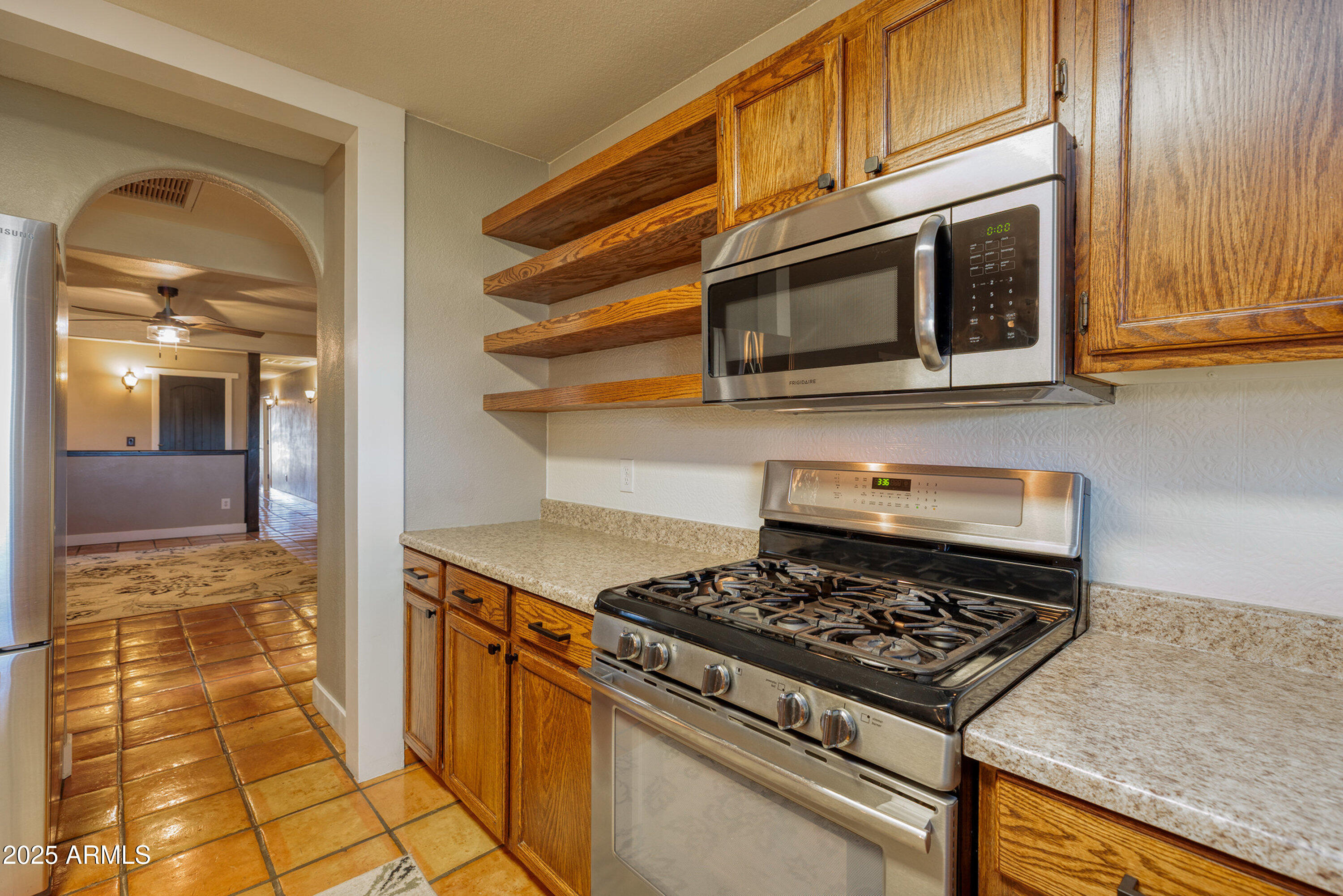 981 Oak Grove Road Show Low, AZ 85901 - Photo 19 of 61 a kitchen with a stove and a microwave