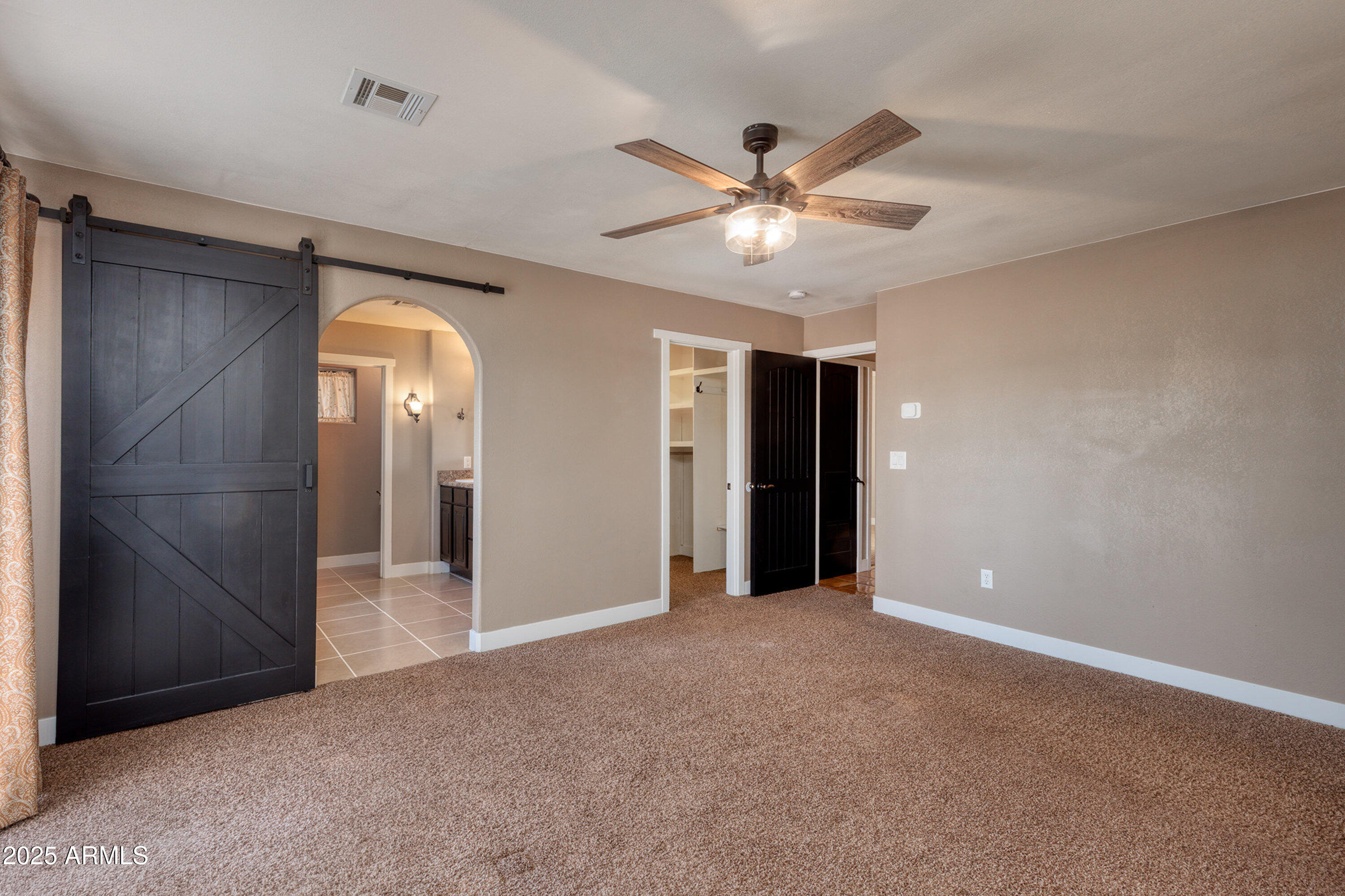 981 Oak Grove Road Show Low, AZ 85901 - Photo 26 of 61 an empty room with closet and a chandelier fan