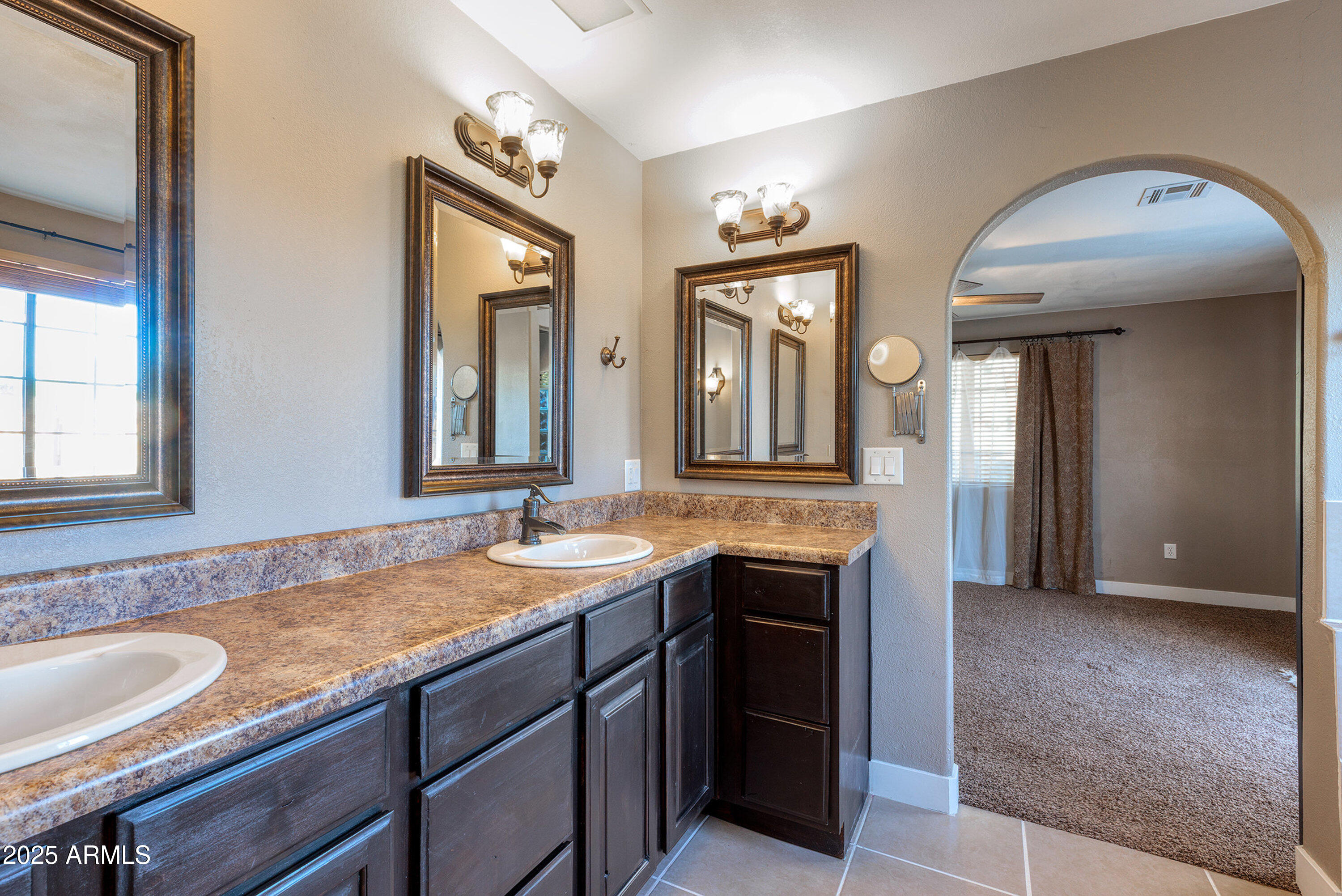981 Oak Grove Road Show Low, AZ 85901 - Photo 30 of 61 a bathroom with a granite countertop sink and a mirror