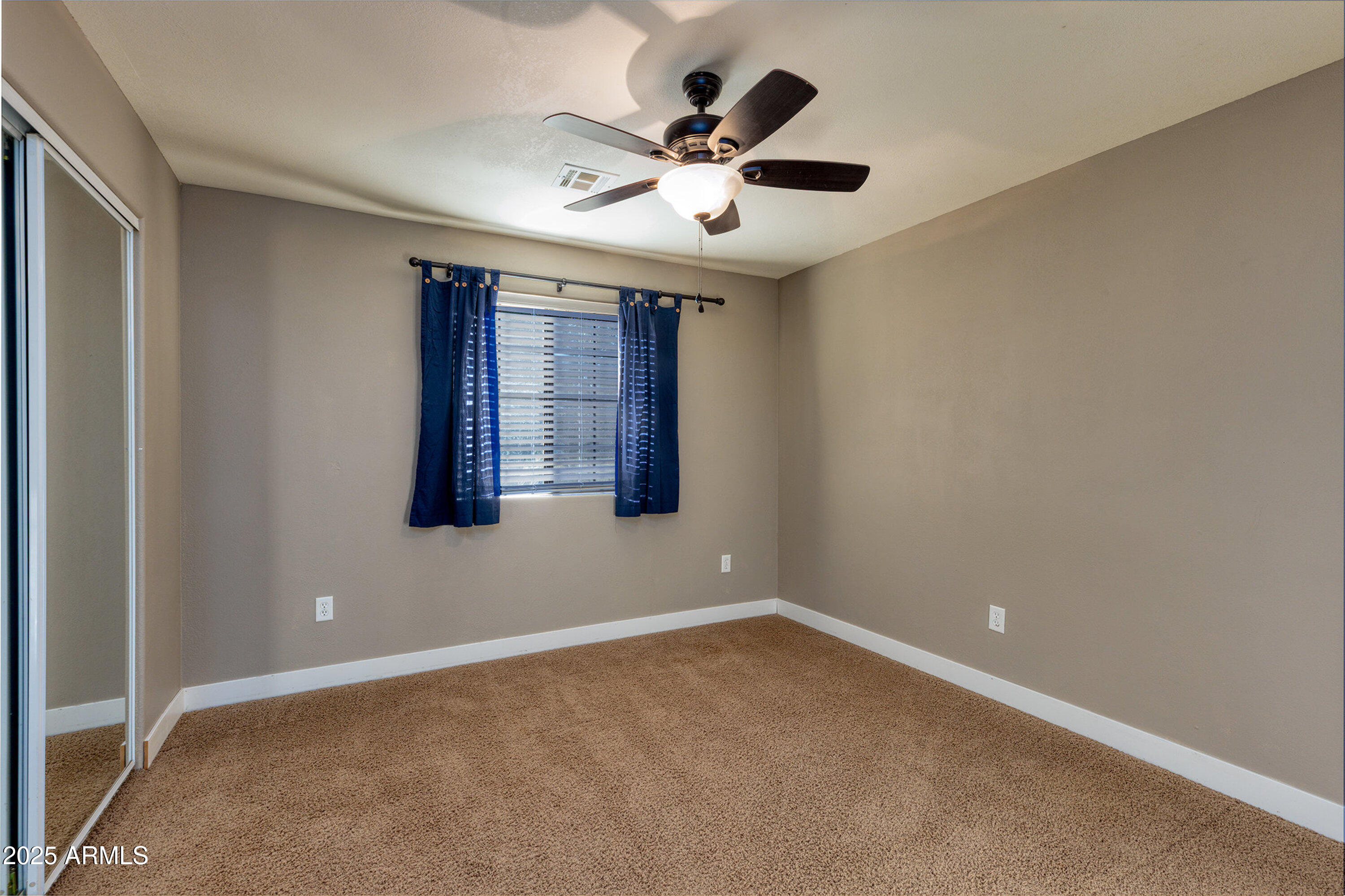 981 Oak Grove Road Show Low, AZ 85901 - Photo 35 of 61 en empty room with ceiling fan and window