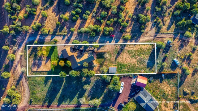 an aerial view of a house with a yard and garden
