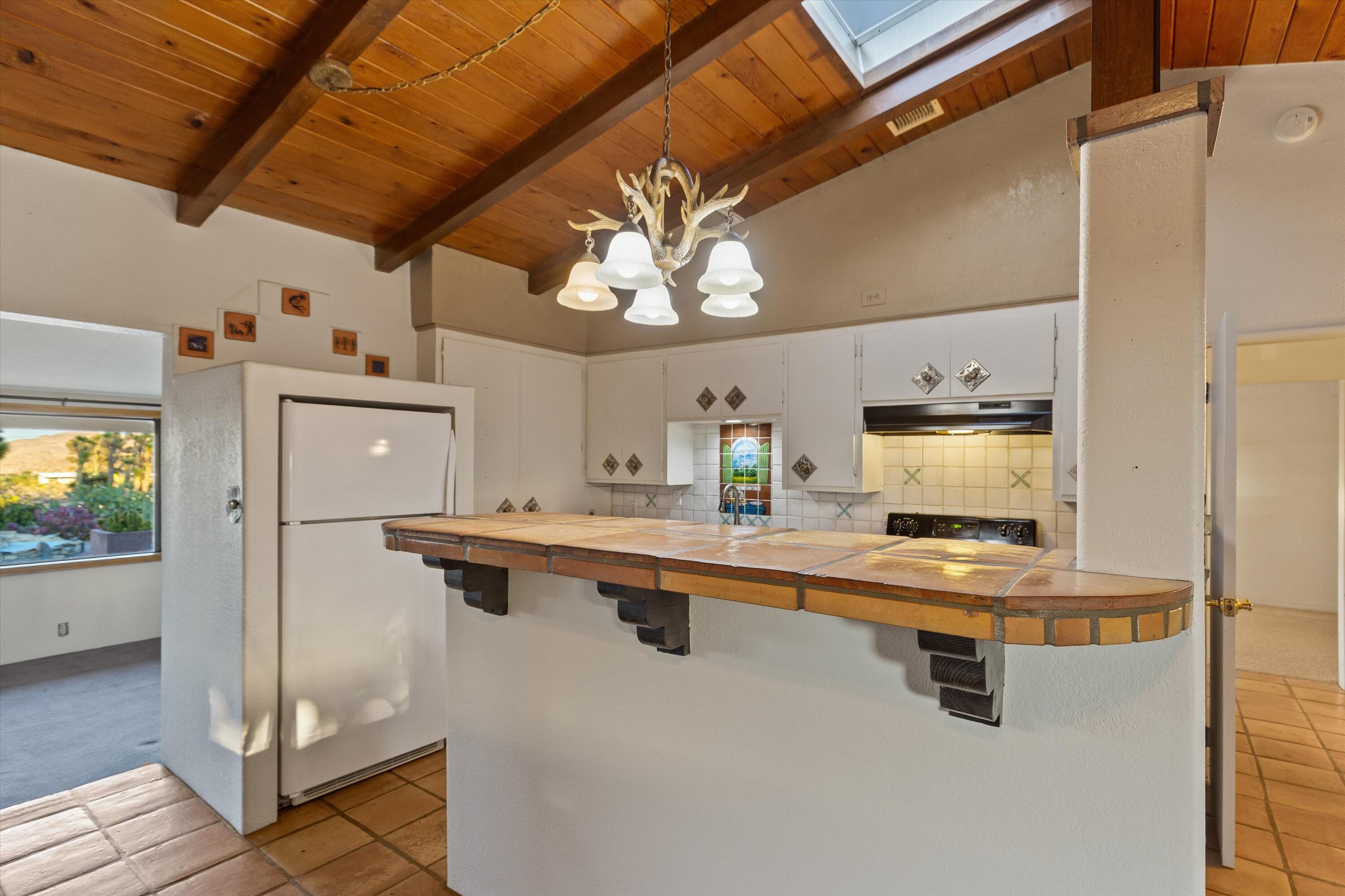 6785 Saddleback Road Joshua Tree, CA 92252 - Photo 18 of 50 a kitchen with stainless steel appliances granite countertop a sink a stove and a refrigerator