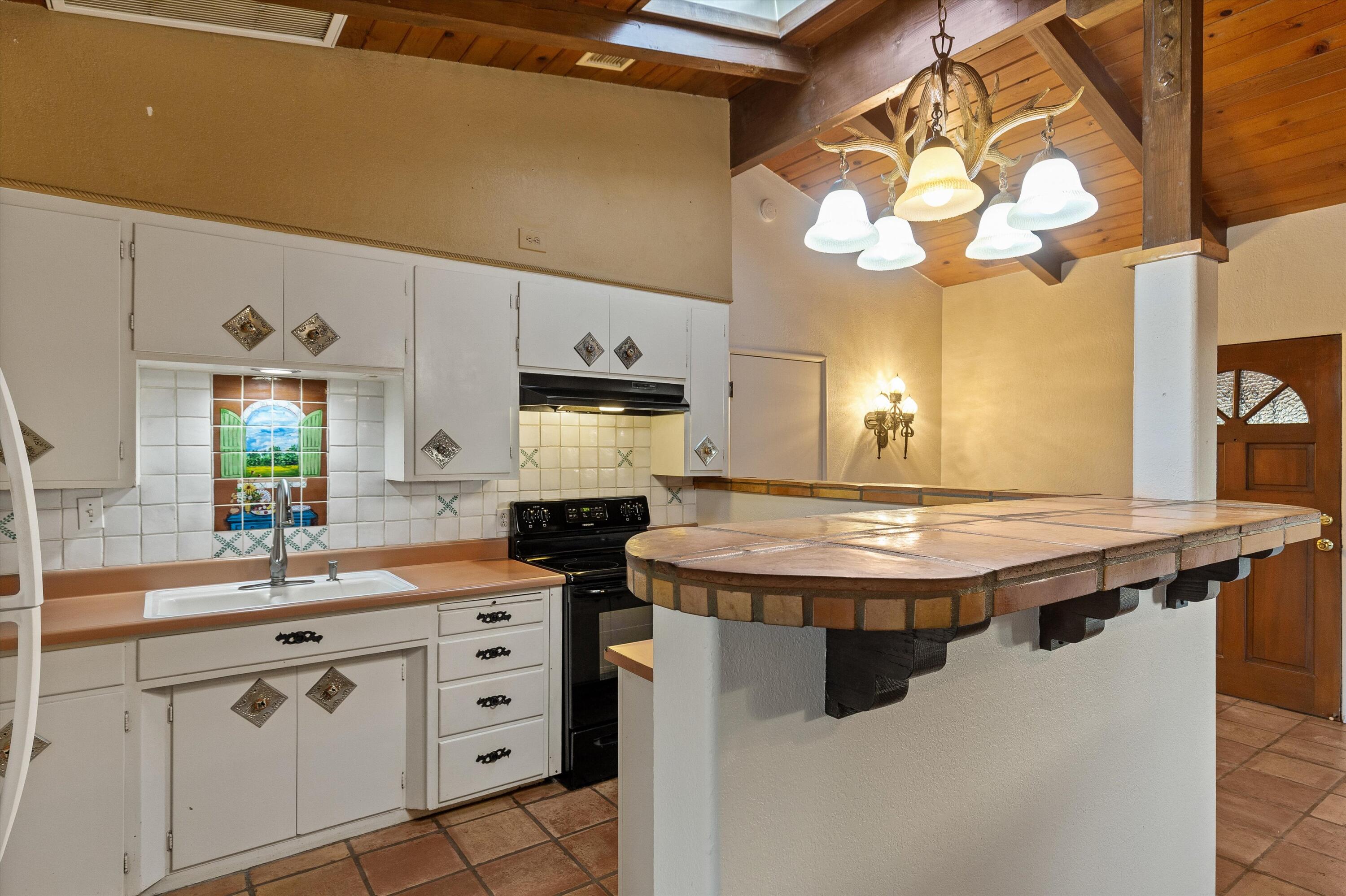 6785 Saddleback Road Joshua Tree, CA 92252 - Photo 22 of 50 a kitchen with stainless steel appliances a stove a sink and a refrigerator