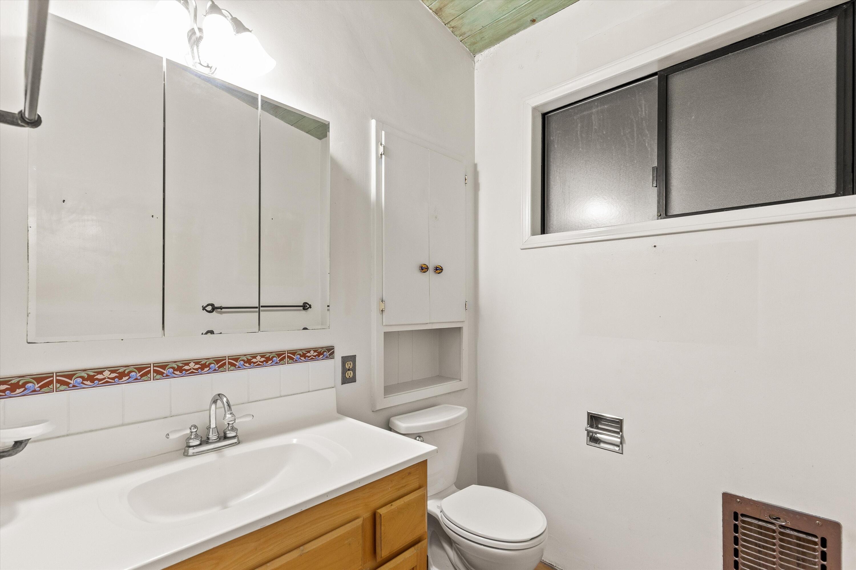 6785 Saddleback Road Joshua Tree, CA 92252 - Photo 27 of 50 a bathroom with a sink a toilet and vanity