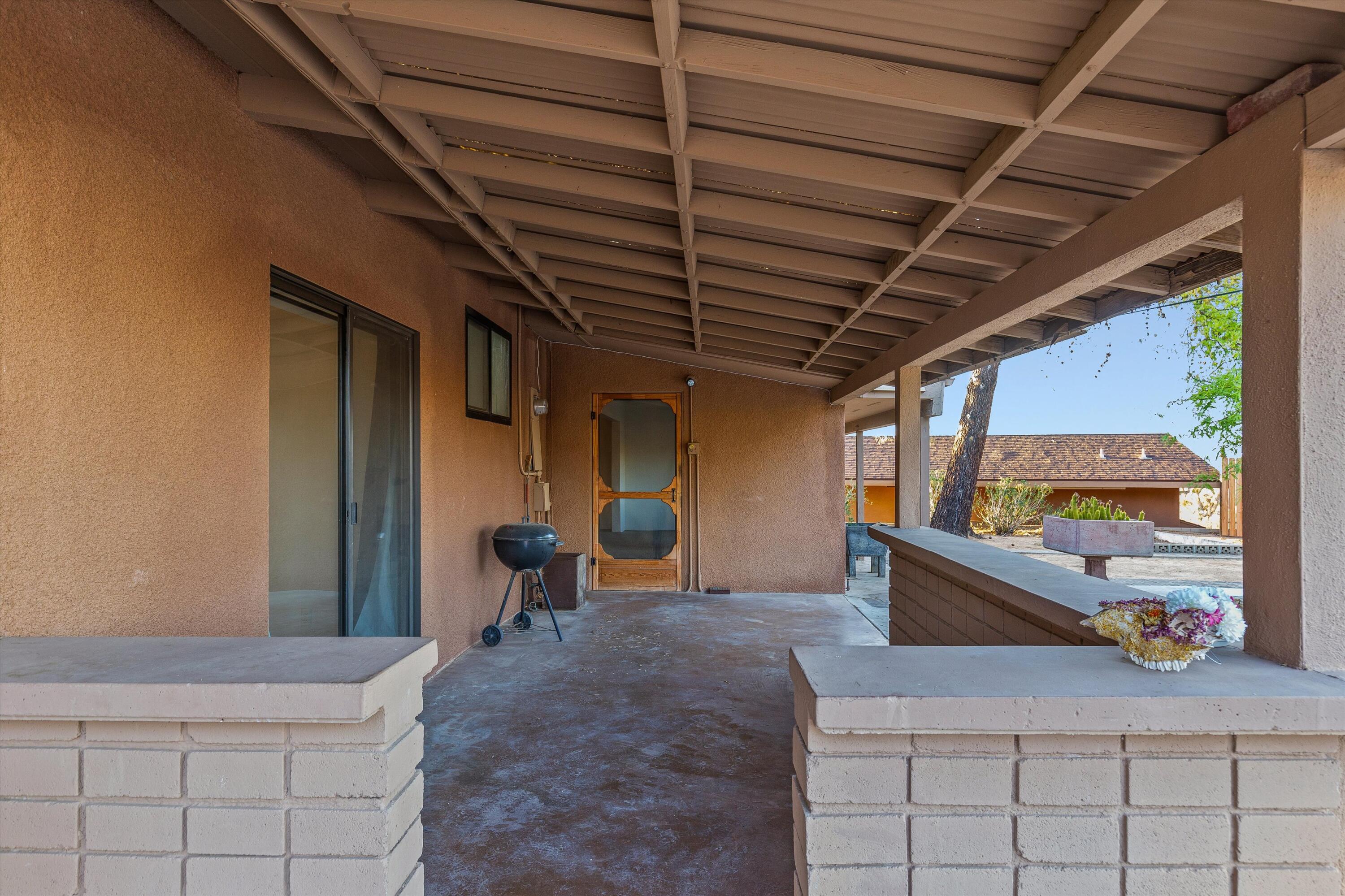 6785 Saddleback Road Joshua Tree, CA 92252 - Photo 30 of 50 a view of a porch with furniture and a table