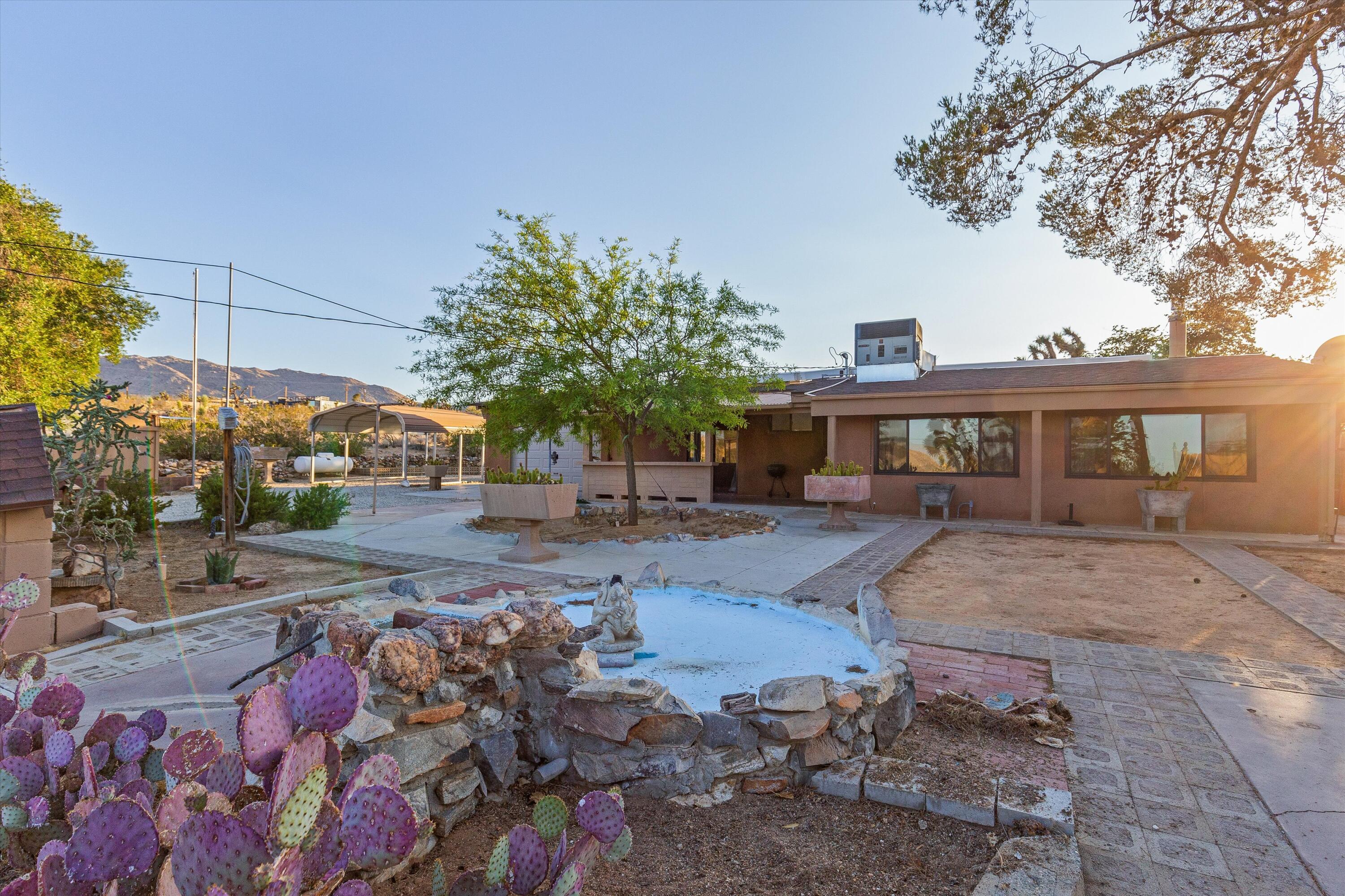 6785 Saddleback Road Joshua Tree, CA 92252 - Photo 33 of 50 a front view of a house with garden