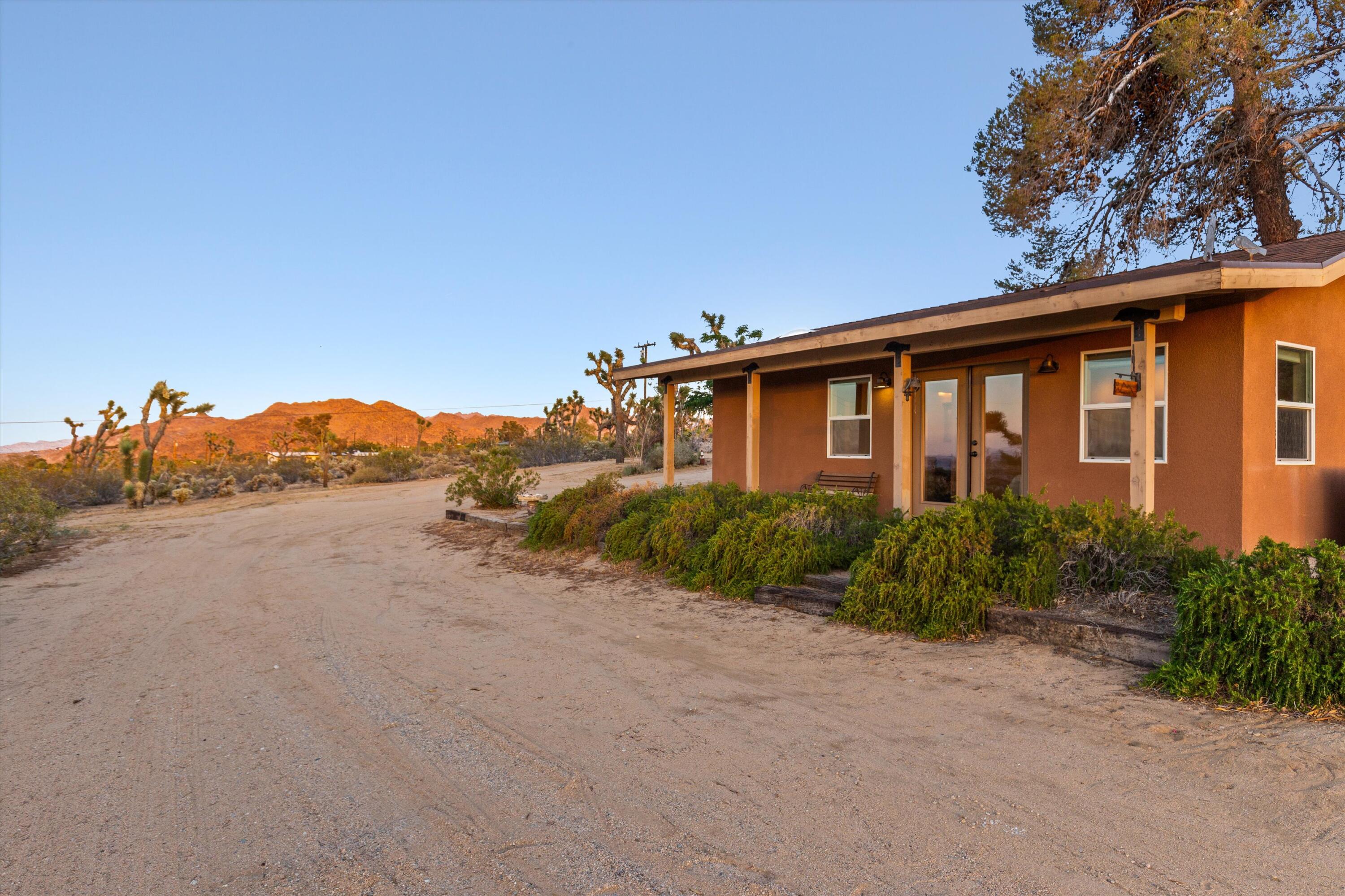 6785 Saddleback Road Joshua Tree, CA 92252 - Photo 35 of 50 a front view of a house with a yard