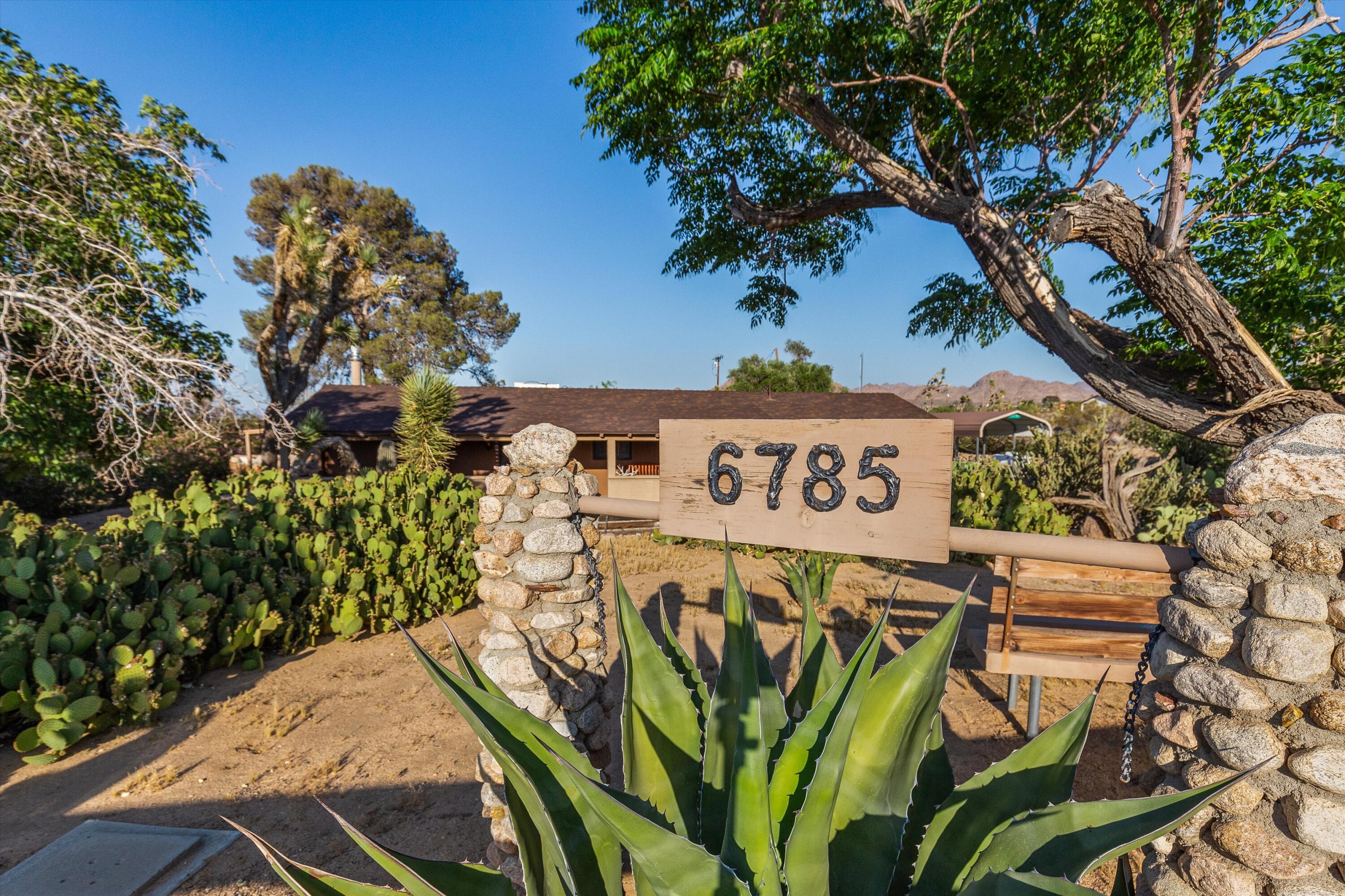 6785 Saddleback Road Joshua Tree, CA 92252 - Photo 4 of 50 a view of a sign in a yard