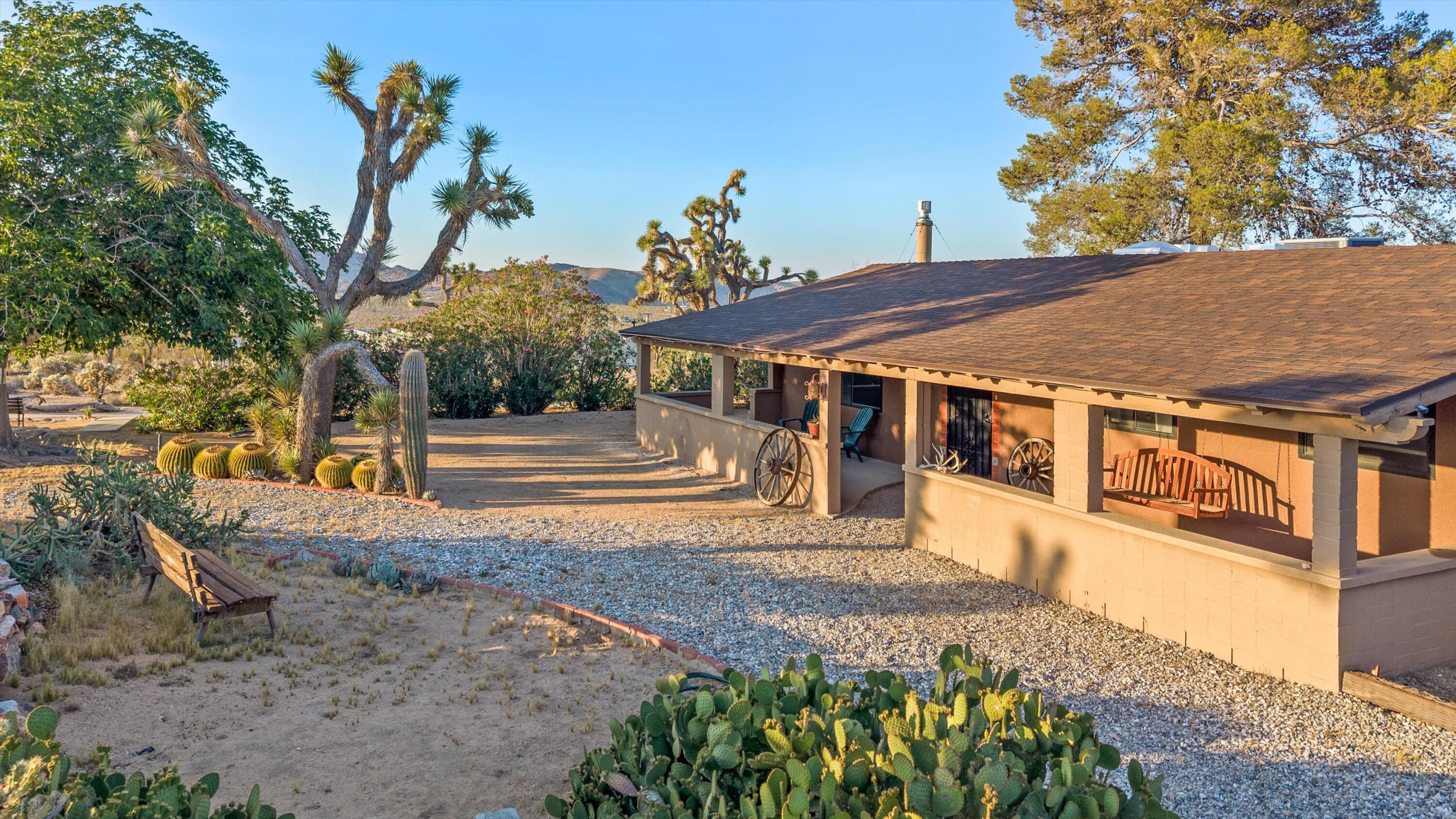 6785 Saddleback Road Joshua Tree, CA 92252 - Photo 6 of 50 a front view of a house with a yard
