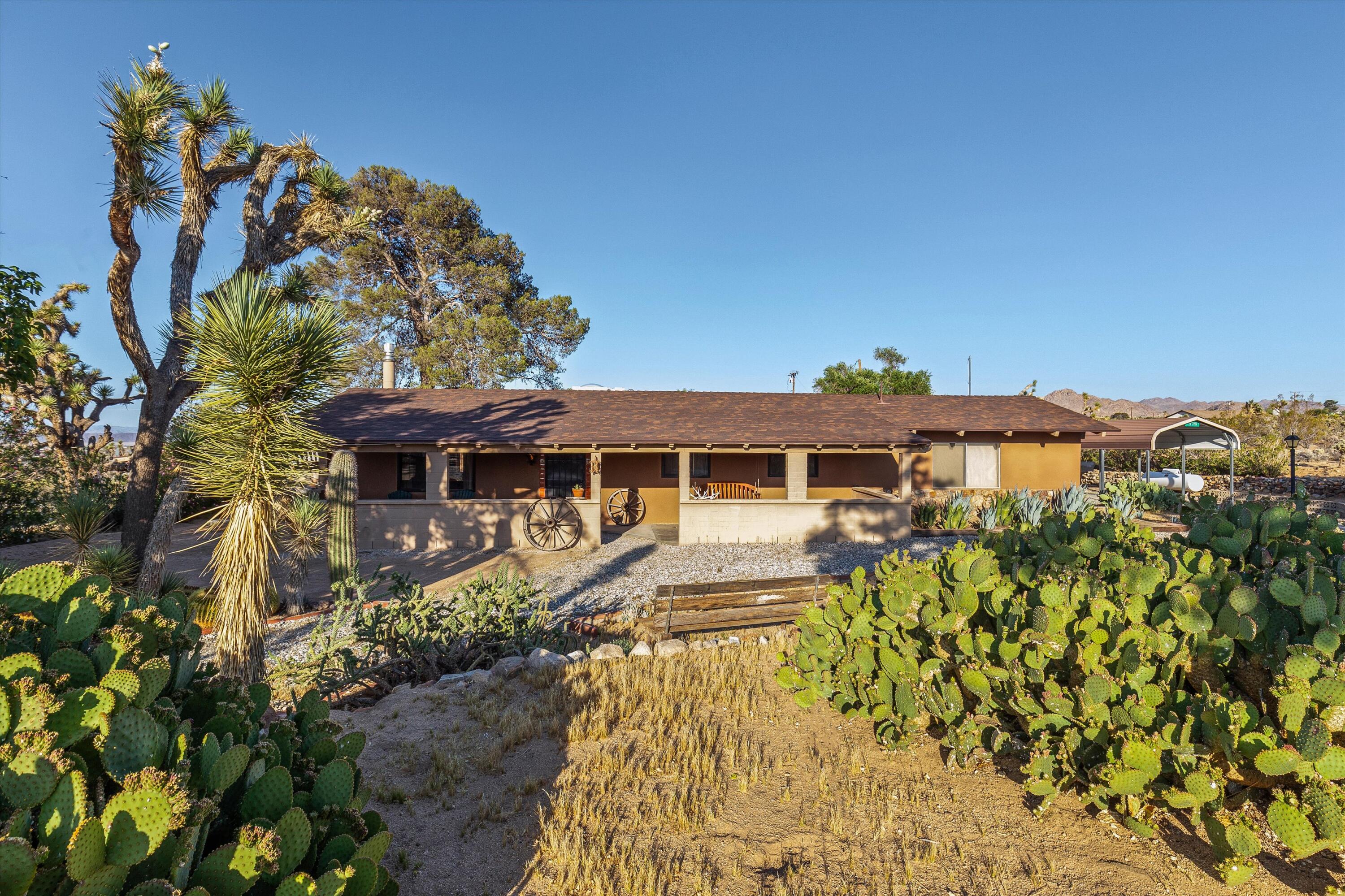 6785 Saddleback Road Joshua Tree, CA 92252 - Photo 10 of 50 a front view of a house with a yard