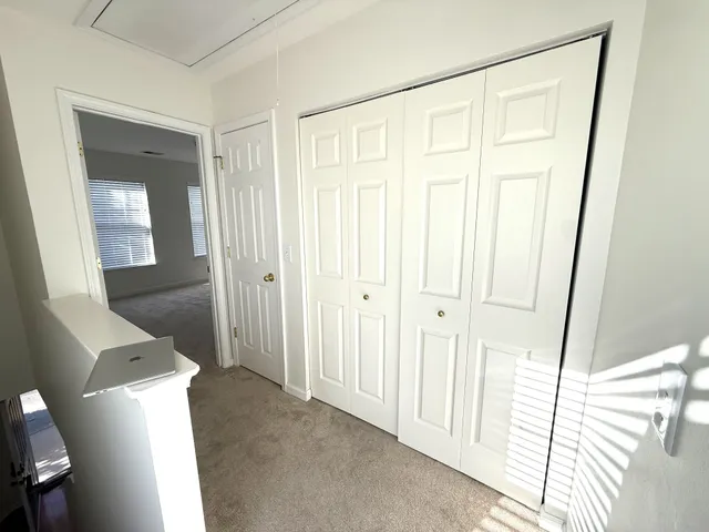 a view of a room with wooden floor and bathroom