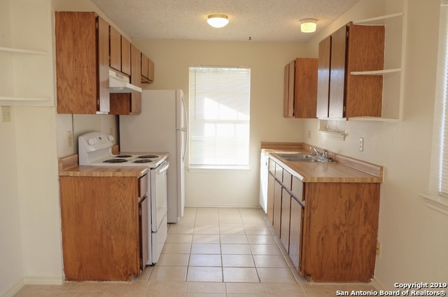 12250 Ridge Crown Street San Antonio, TX 78247 - Photo 4 of 15 a bathroom with a sink a vanity and a mirror