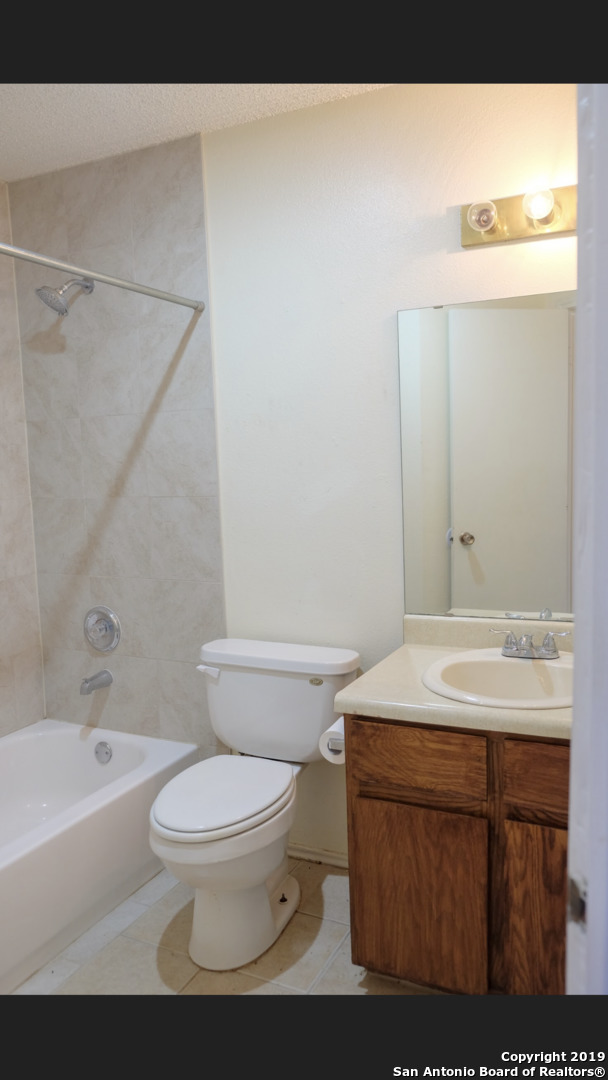 12250 Ridge Crown Street San Antonio, TX 78247 - Photo 9 of 15 a bathroom with a sink a toilet and shower