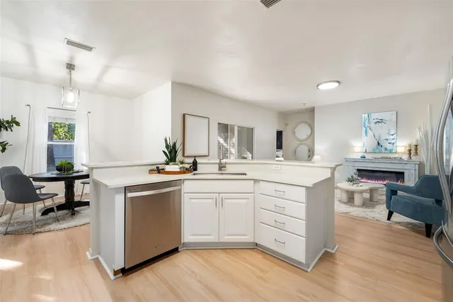 a kitchen with sink stove and wooden floor