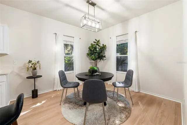 a dining room with furniture and wooden floor