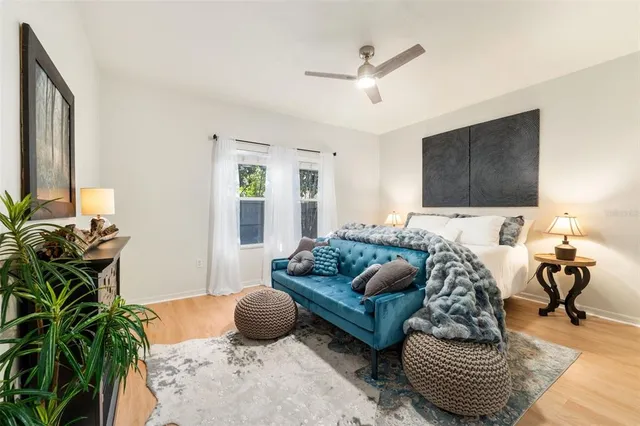 a bedroom with furniture and a potted plant