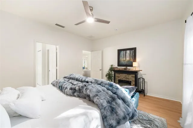 a bedroom with a bed a large window and chair