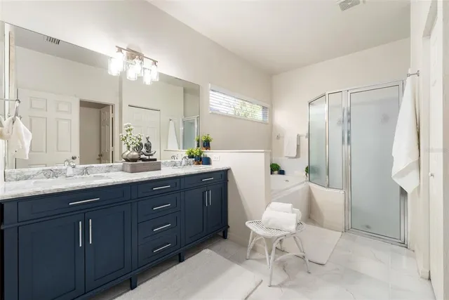 a bathroom with a double vanity sink toilet and a mirror