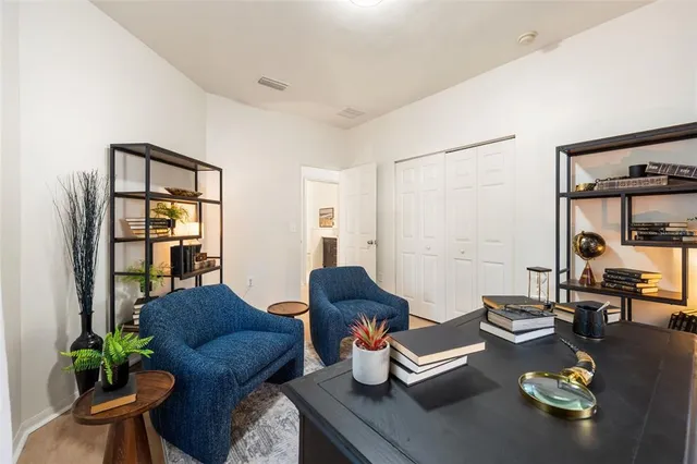 a living room with furniture and wooden floor