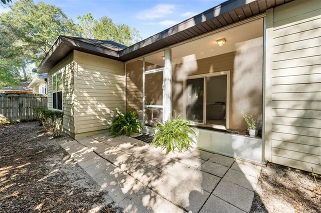 a view of a house with potted plants