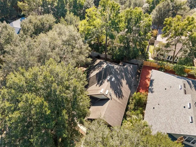 an aerial view of a house with a yard