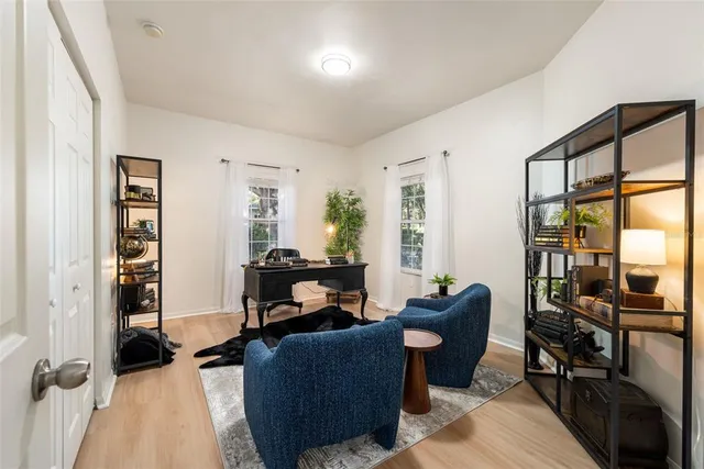a living room with furniture and a floor to ceiling window