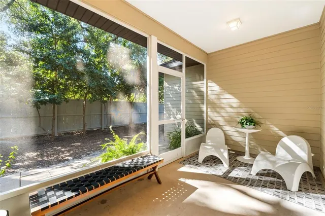 a view of a chairs and table in patio with wooden fence