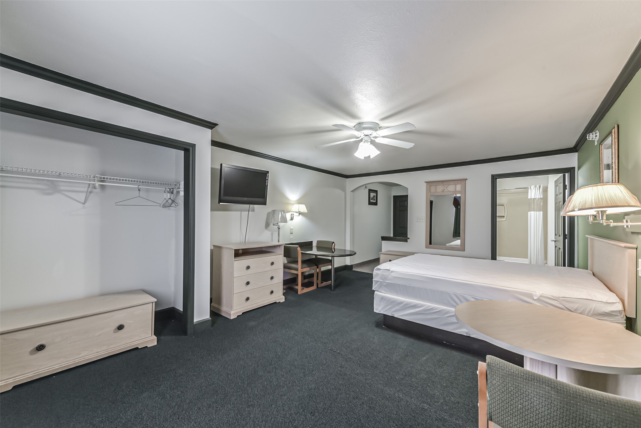 1025 Swanson Street, Unit 313 Houston, TX 77030 - Photo 12 of 25 a spacious bedroom with a bed and a chandelier