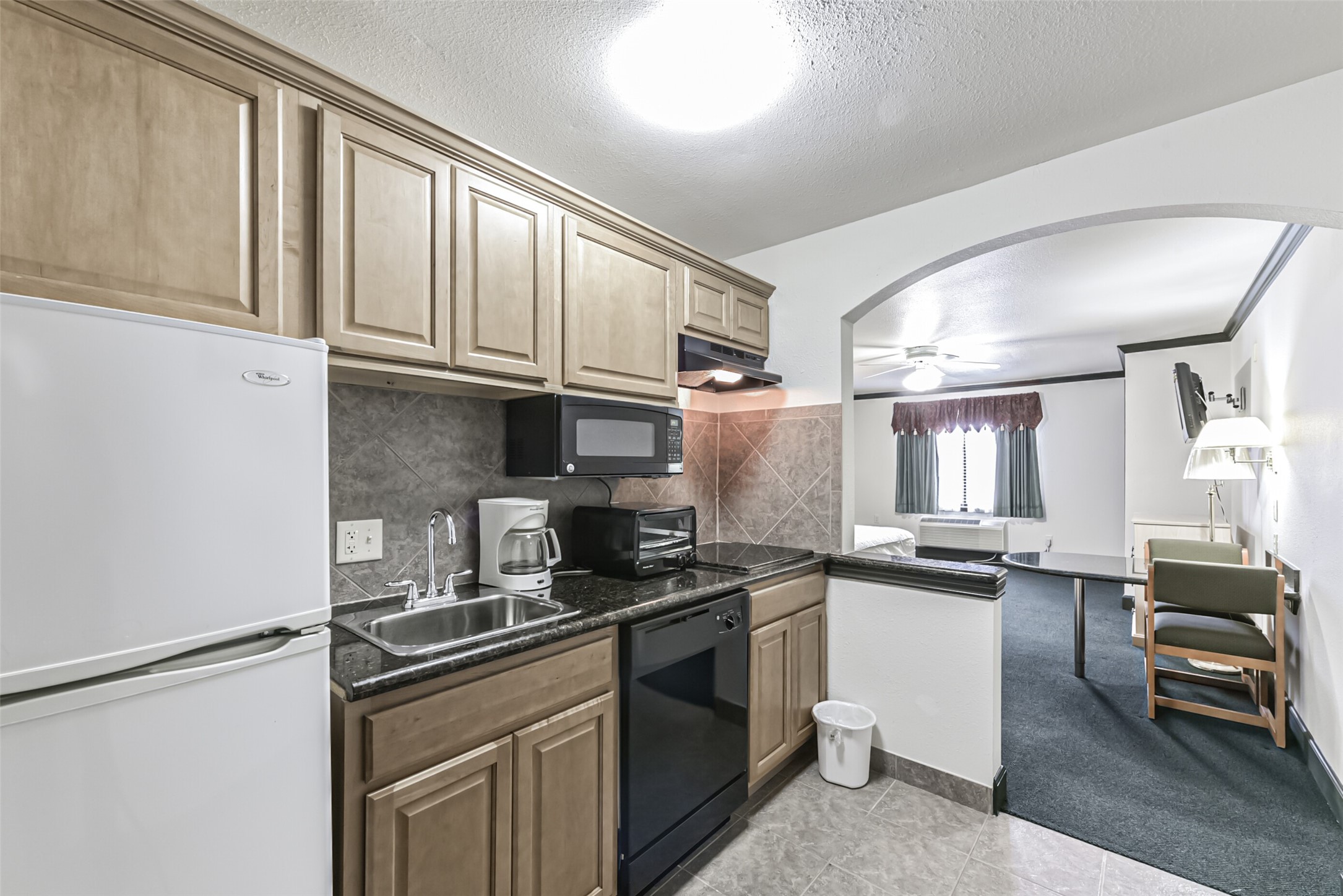 1025 Swanson Street, Unit 313 Houston, TX 77030 - Photo 16 of 25 a kitchen with granite countertop a sink stainless steel appliances and cabinets