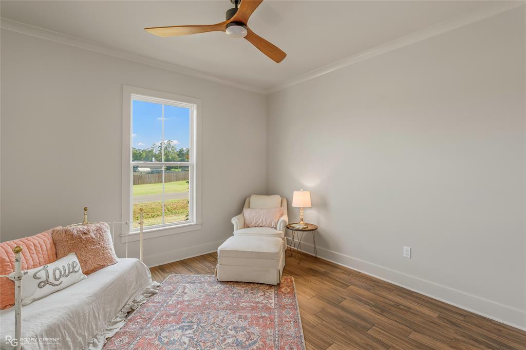 219 Marble Place Haughton, LA 71037 - Photo 26 of 29 Spacious room featuring wood-finish flooring, a contemporary ceiling fan, and crown molding