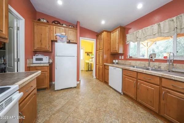 a kitchen with a refrigerator and a sink