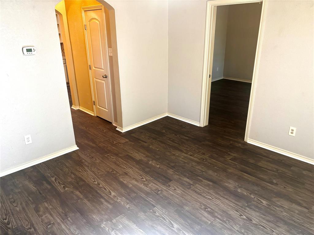 905 Isbell Road Fort Worth, TX 76114 - Photo 9 of 30 a view of a hallway with wooden floor