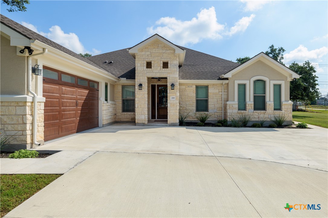 200 Wood Cove Georgetown, TX 78633 - Photo 3 of 22 a front view of a house with a garden