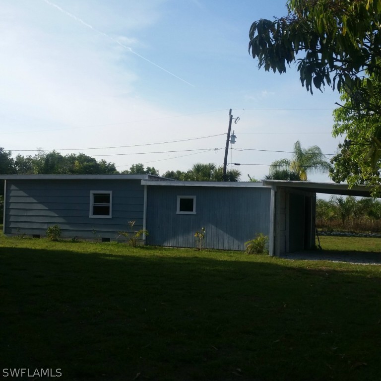 15272 Stringfellow Road Bokeelia, FL 33922 - Photo 3 of 21 a view of house with backyard outdoor space and lake view