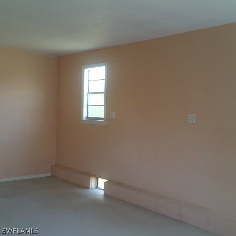 15272 Stringfellow Road Bokeelia, FL 33922 - Photo 4 of 21 an empty room with a window