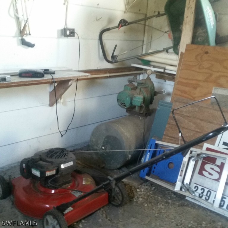 15272 Stringfellow Road Bokeelia, FL 33922 - Photo 6 of 21 a room with water heater and wooden cabinets