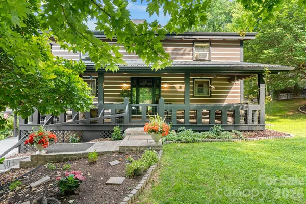 an outdoor view of house with swimming pool and furniture