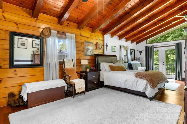 a spacious bedroom with a bed and wooden floors