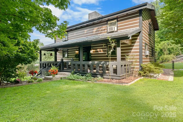 a front view of a house with patio and garden