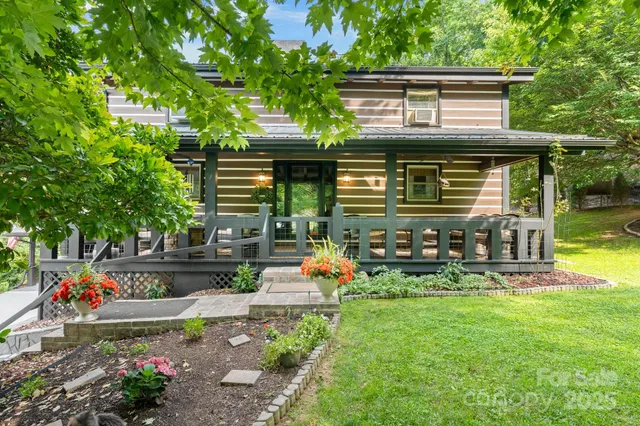 an outdoor view of house with swimming pool and furniture
