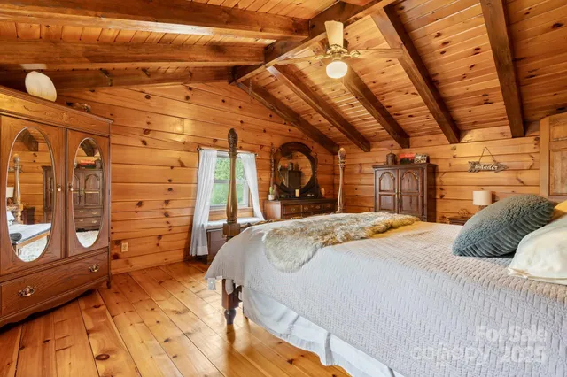 a bedroom with a bed and a mirror