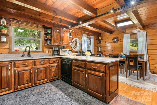 a kitchen with stainless steel appliances granite countertop a sink and cabinets