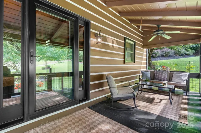 a porch with a bench next to a yard